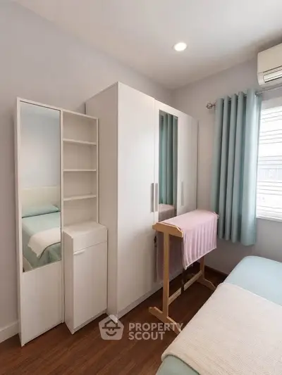 Cozy bedroom with modern wardrobe and natural light