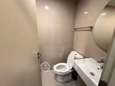Modern bathroom with sleek design and round mirror