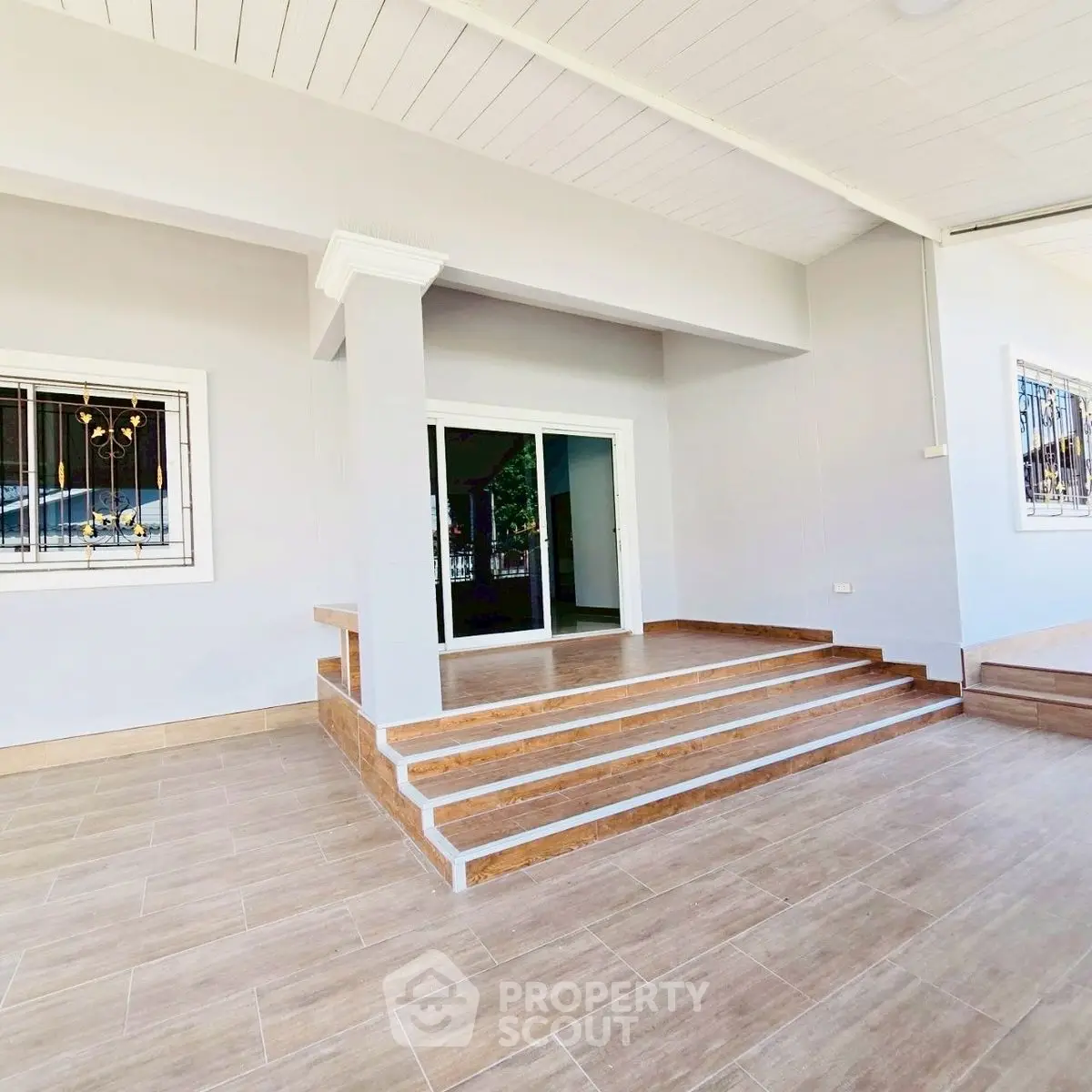 Spacious modern entrance with elegant tiled steps and large windows