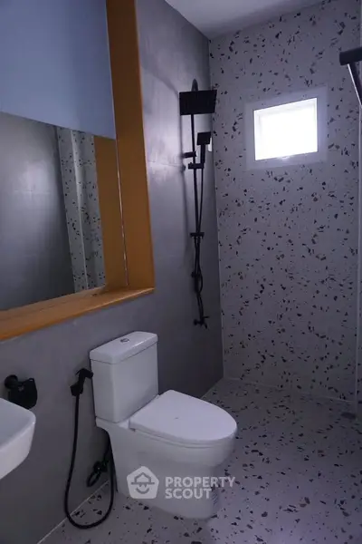 Modern bathroom with terrazzo tiles and sleek fixtures