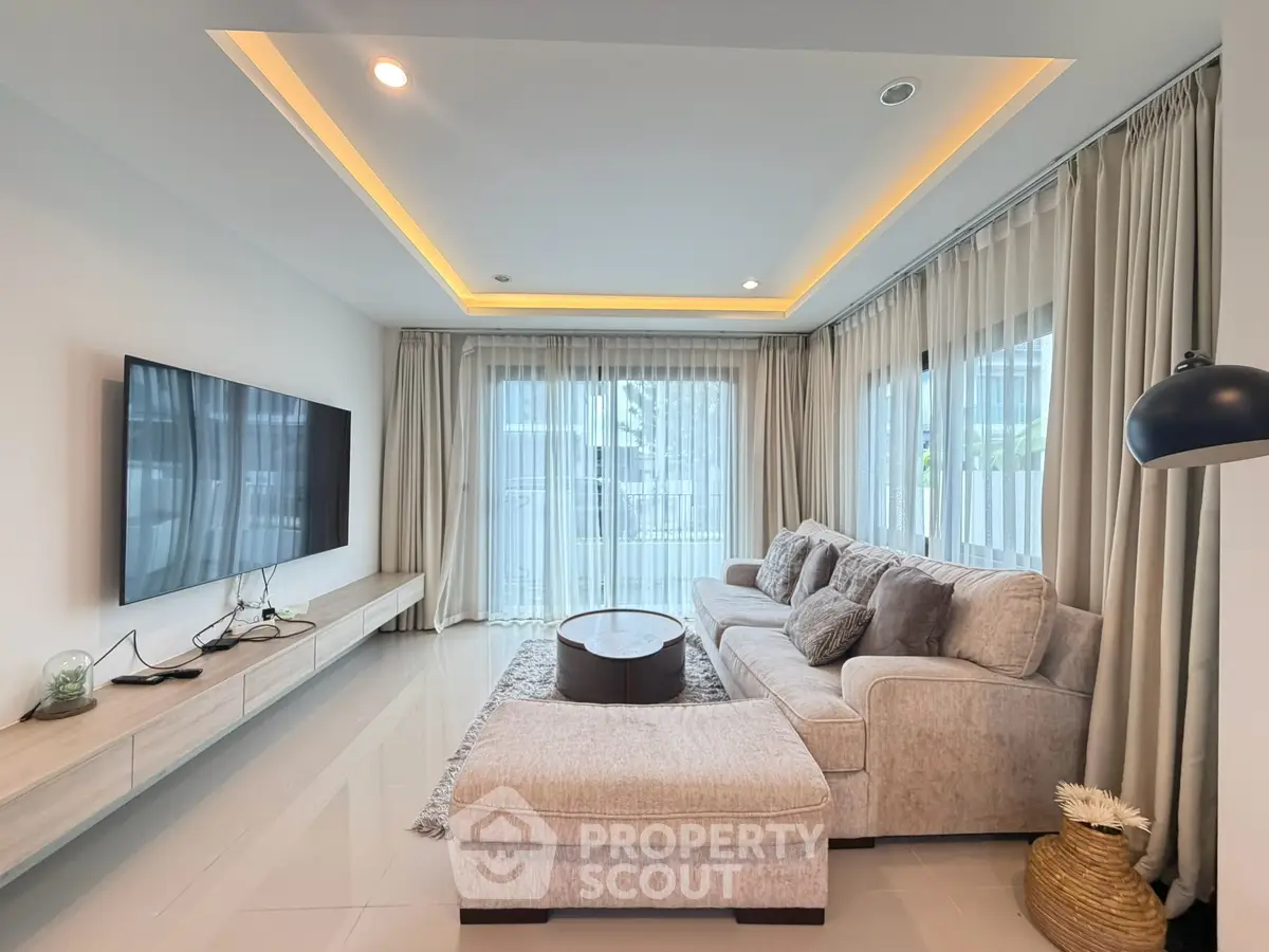 Luxurious modern living room with elegant lighting and plush seating in a spacious corner unit.