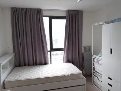 Cozy bedroom with large window and ample storage space