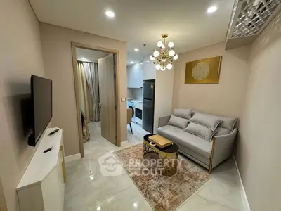 Modern living room with elegant decor and compact kitchen area.