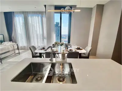 Luxurious open-plan kitchen and dining area with stunning city view, modern fixtures, and elegant decor.
