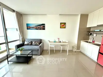 Modern living room with sleek kitchen and balcony view in stylish apartment
