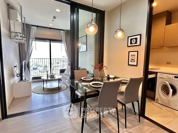 Modern apartment with open layout, dining area, and cozy living room with balcony view.