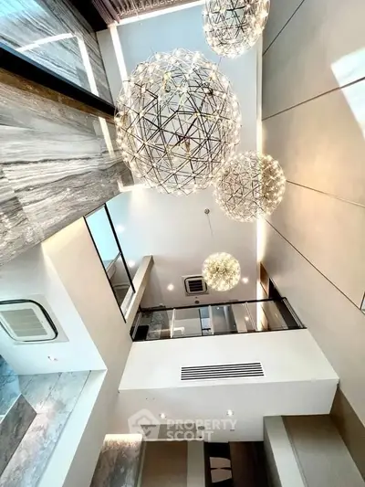 Luxurious modern interior with stunning chandelier lighting and high ceilings