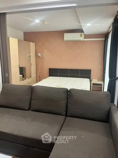 Cozy bedroom with modern furniture and air conditioning, perfect for comfortable living.