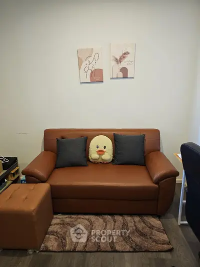 Cozy living room with brown leather sofa and cute plush decor