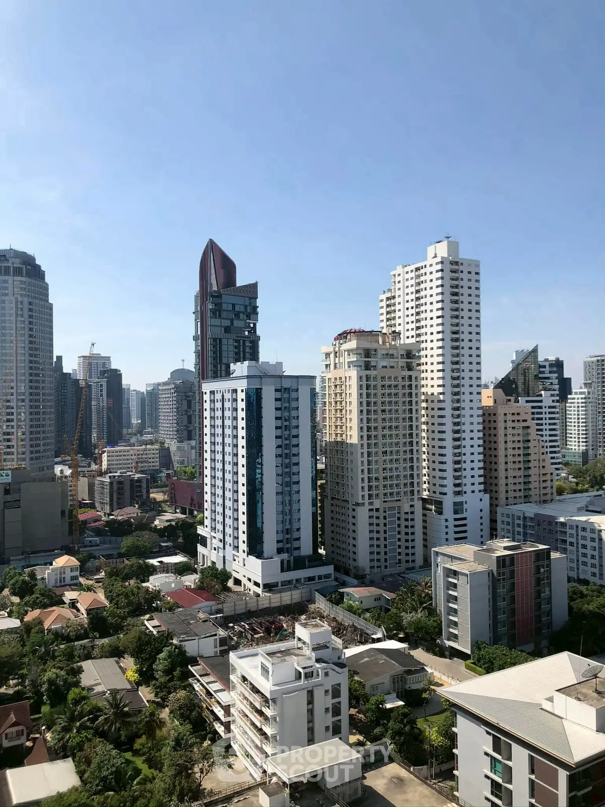 Stunning cityscape view of modern high-rise buildings under clear blue sky