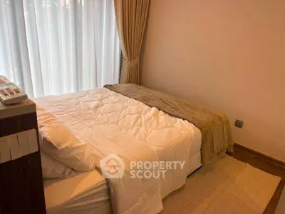 Cozy bedroom with elegant curtains and soft lighting, perfect for relaxation.