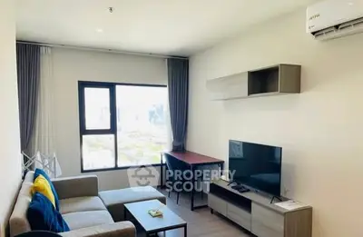 Modern living room with city view, cozy sofa, TV, and stylish decor.