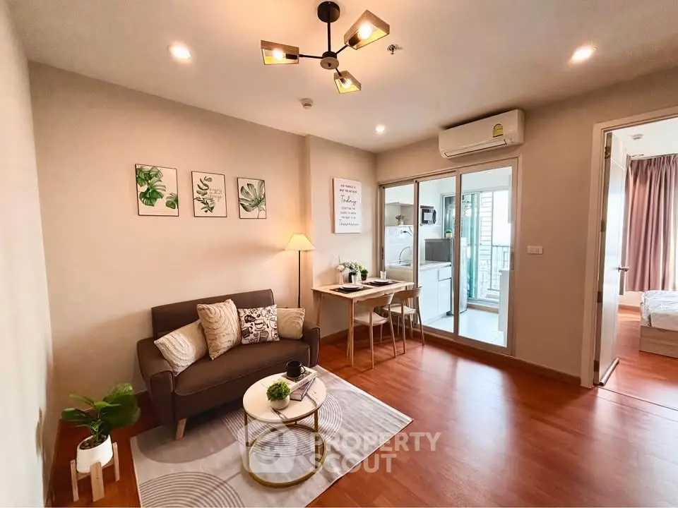 Modern living room with cozy sofa, stylish decor, and open kitchen layout in a chic apartment.