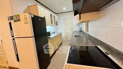 Modern kitchen with sleek countertops and appliances in a stylish home.