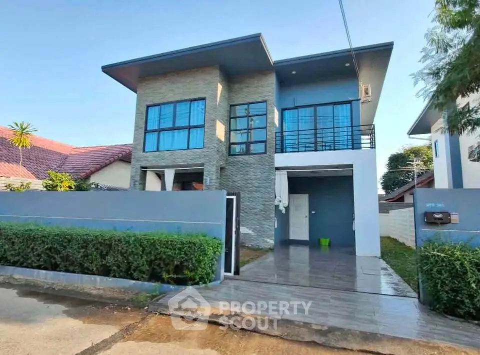 Modern two-story house with sleek design and spacious driveway in a serene neighborhood.