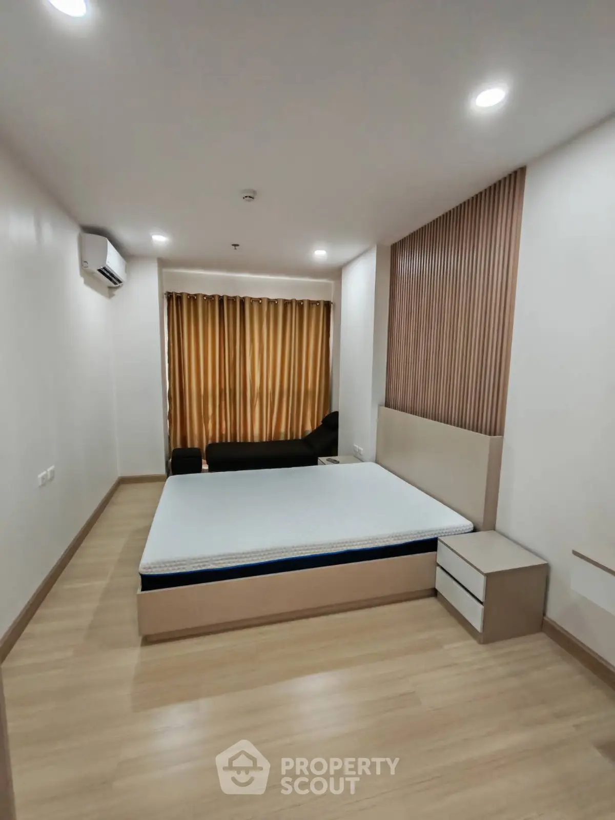 Modern bedroom with minimalist design and wooden flooring