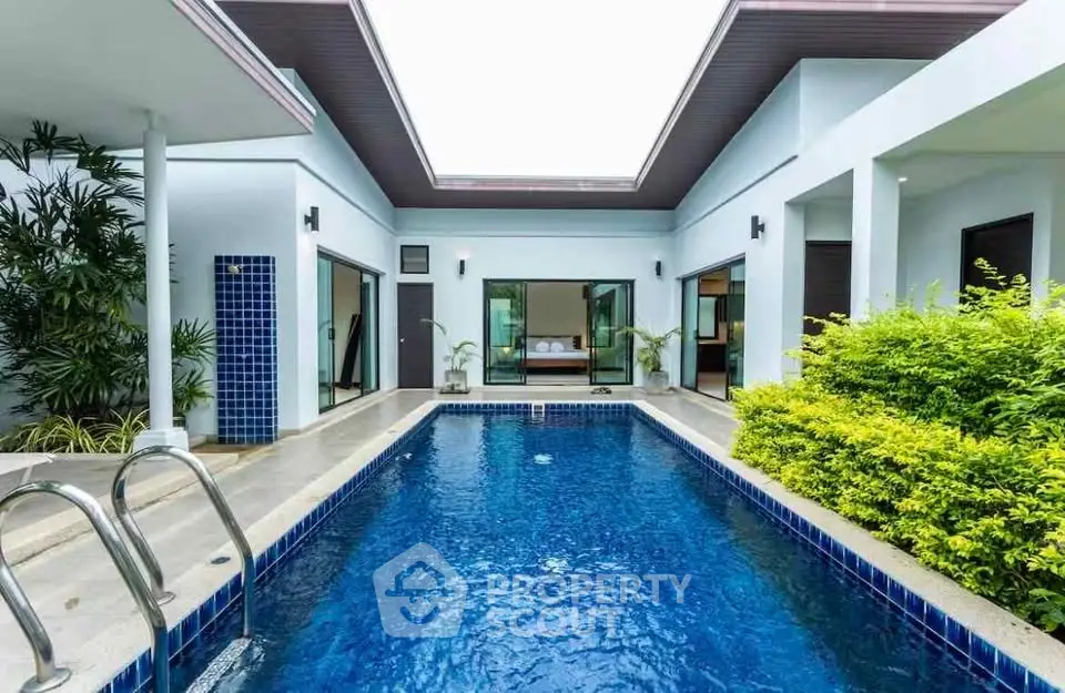 Luxurious modern villa with private pool and lush greenery, perfect for relaxation and entertaining.