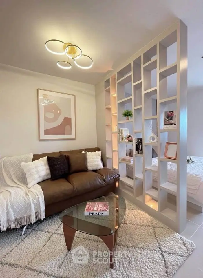 Stylish living room with modern decor and cozy seating area, featuring a unique partition wall.