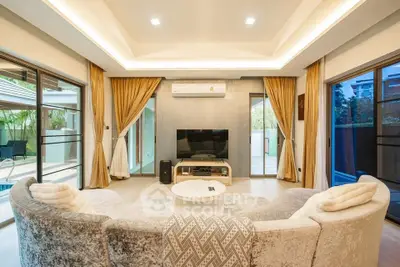 Luxurious living room with plush sofa, modern decor, and pool view, perfect for relaxation and entertainment.