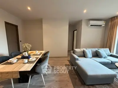 Modern living room with stylish dining area and cozy sectional sofa, perfect for entertaining.