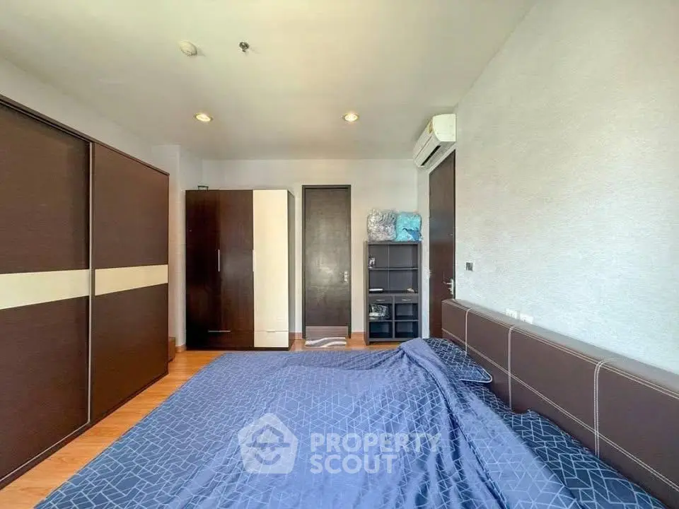 Spacious bedroom with modern furnishings and ample storage space