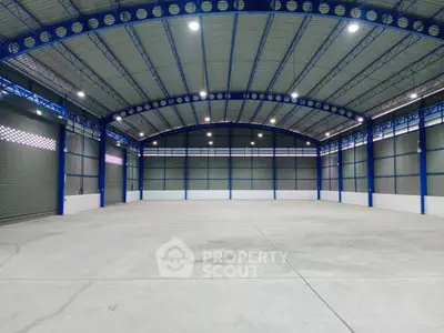 Spacious industrial warehouse with high ceilings and ample lighting