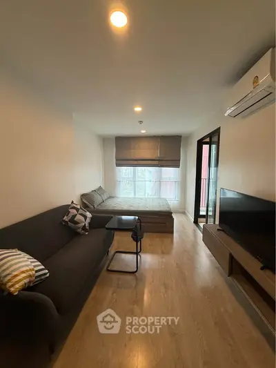 Modern studio apartment with cozy living area and natural light