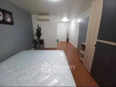 Spacious bedroom with modern decor and ample storage space