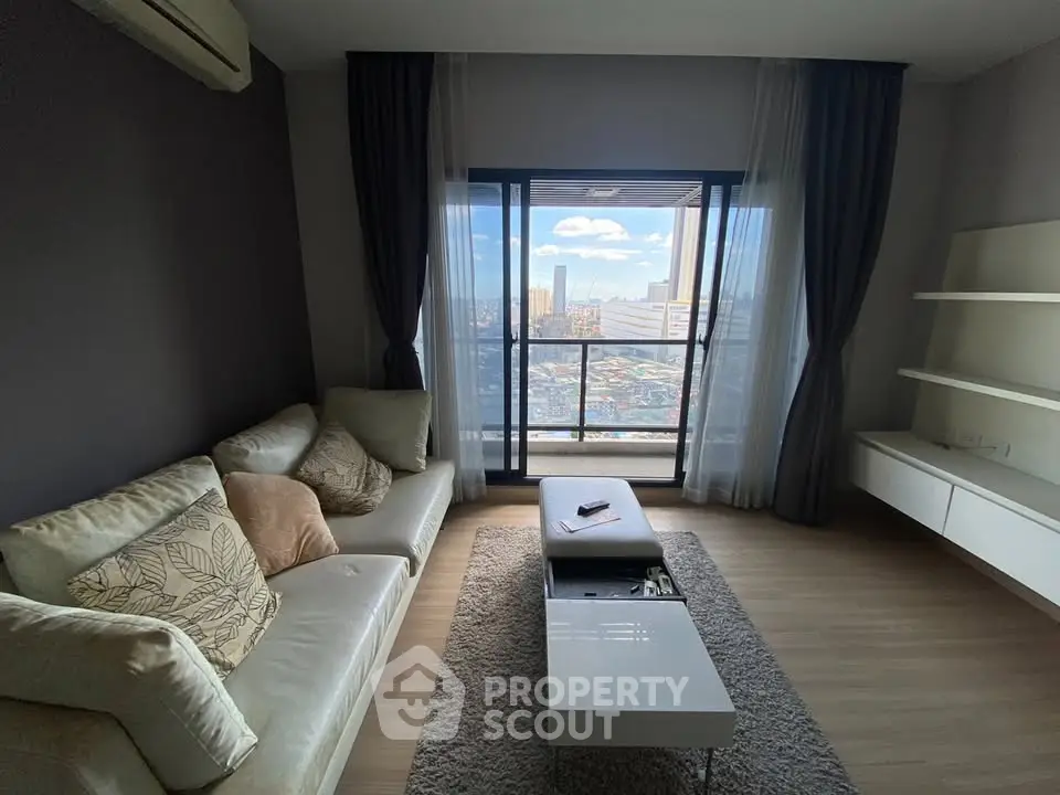 Modern living room with city view, featuring cozy sofa and sleek decor, perfect for urban living.