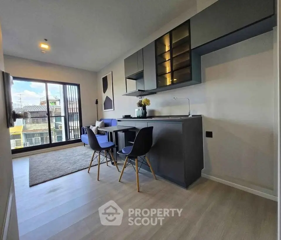 Modern open-layout living room with sleek kitchen and balcony view
