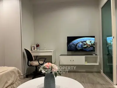 Modern living room with sleek furniture and wall-mounted TV, perfect for cozy relaxation.