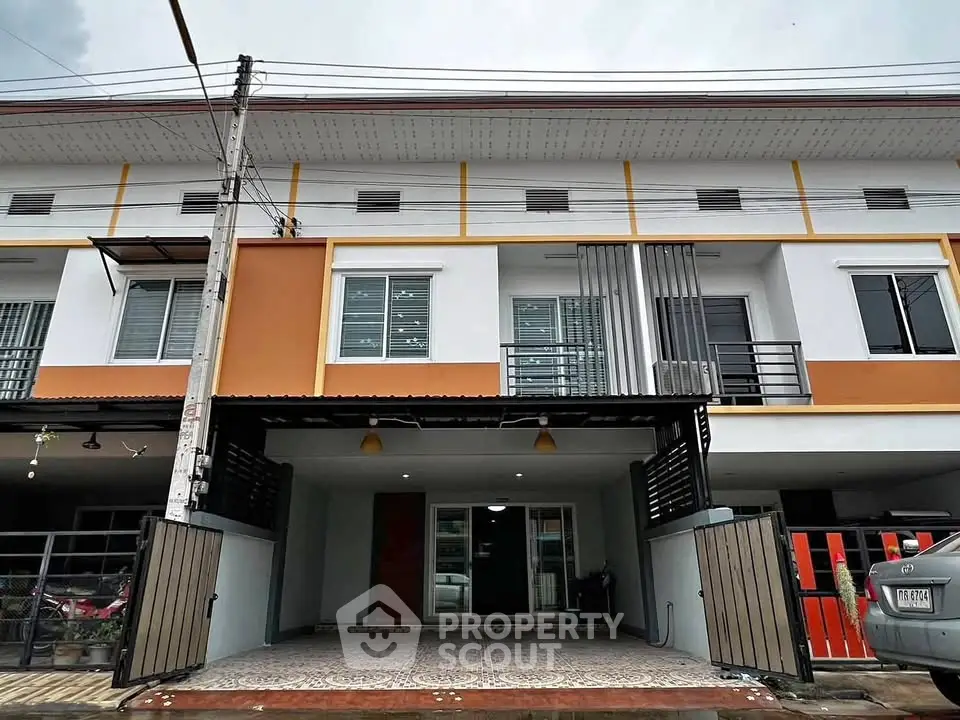 Modern townhouse exterior with spacious driveway and contemporary design.