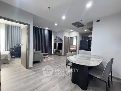 Modern open-plan living and dining area with sleek furnishings and natural light.
