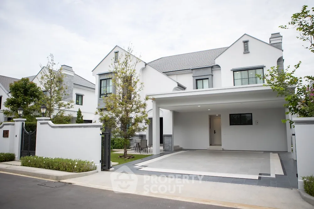 Elegant modern house with spacious driveway and lush greenery