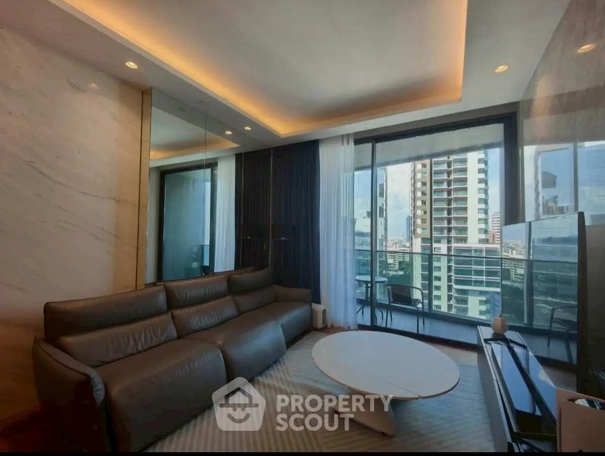 Luxurious living room with modern decor and city view balcony.