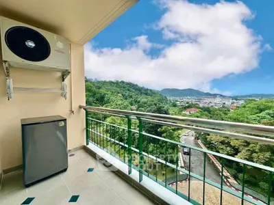 Stunning balcony view with lush greenery and distant mountains, perfect for relaxation.