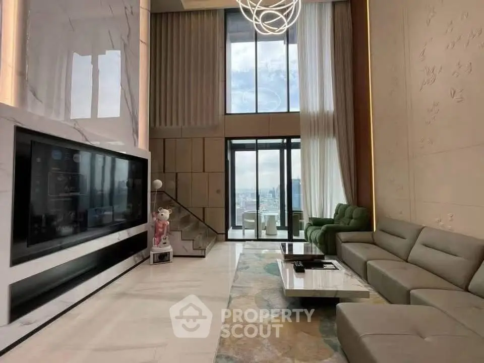 Luxurious high-ceiling living room with modern decor and stunning city view.