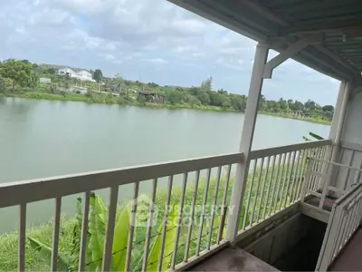 Scenic river view from a spacious balcony in a serene residential area.