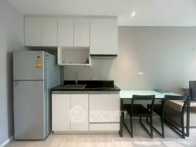 Modern kitchen with sleek cabinetry and dining area in open layout
