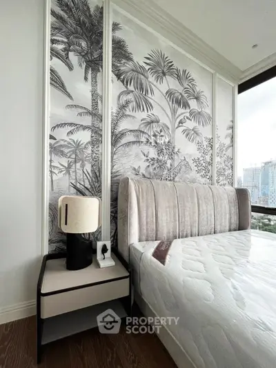 Luxurious bedroom with elegant decor and stunning city view, featuring a plush bed and stylish nightstand.