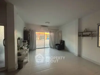 Spacious living room with large window and minimalistic decor