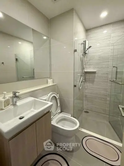 Modern bathroom with glass shower and sleek fixtures