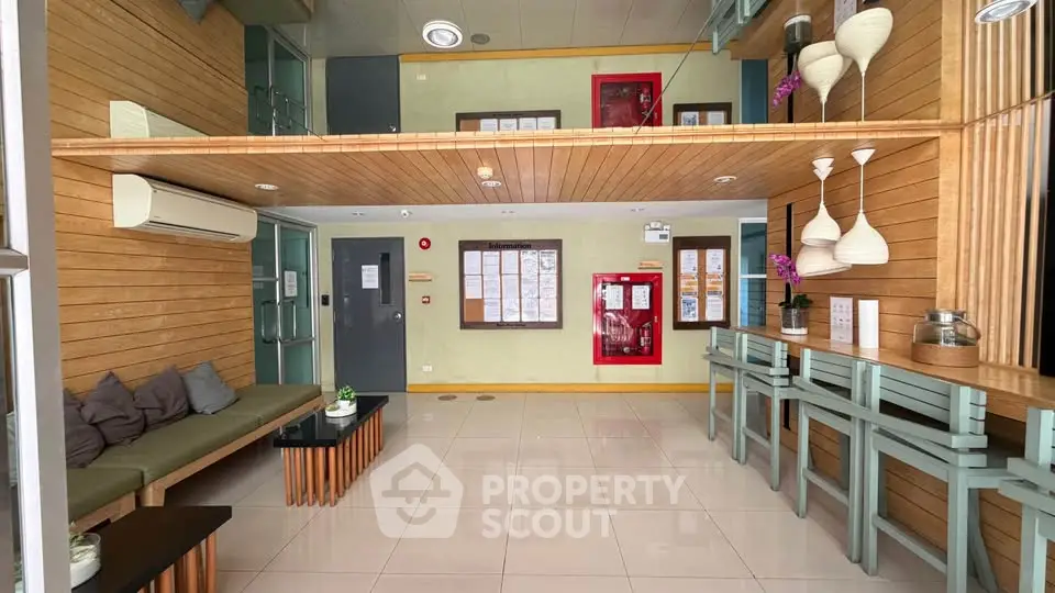 Modern apartment lobby with stylish wooden decor and seating area