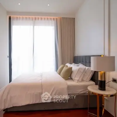 Elegant bedroom with plush bedding and natural light, ideal for relaxation.