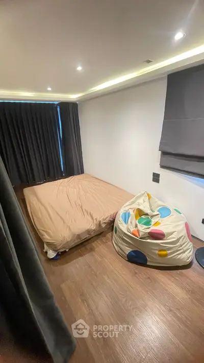 Cozy bedroom with wooden flooring and playful bean bag chair