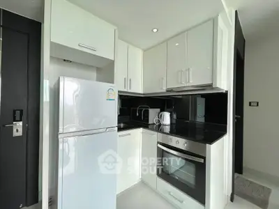 Modern kitchen with sleek white cabinets and built-in appliances