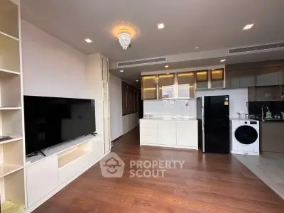 Modern open-plan living room with sleek kitchen and appliances
