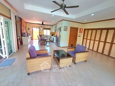 Spacious open-layout living room with modern kitchen and stylish furniture
