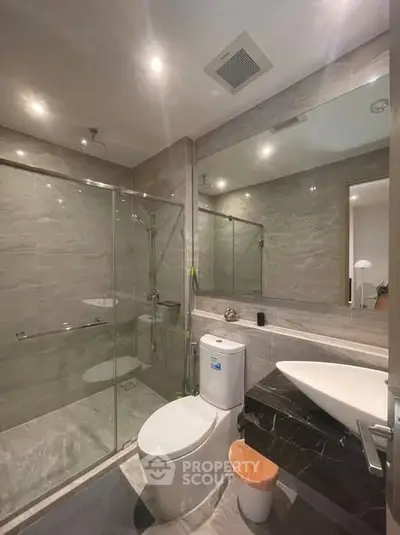 Modern bathroom with glass shower and sleek fixtures