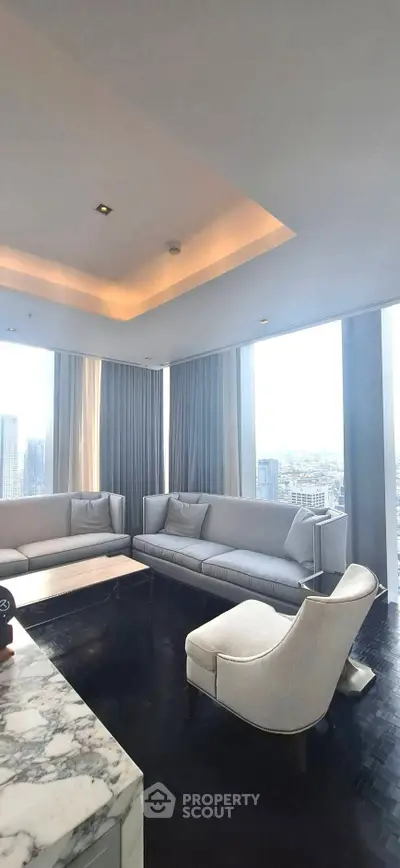 Luxurious high-rise living room with panoramic city views and elegant furnishings.